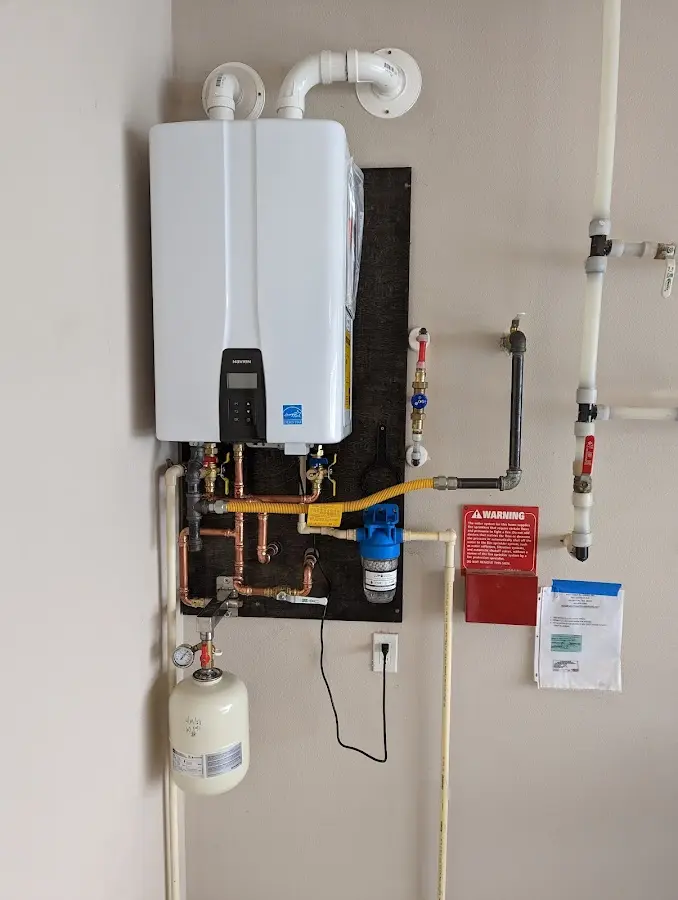 Professional plumber installing copper piping in a La Cienega home